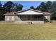 Charming brick home featuring a covered front porch with metal railing and a red metal roof at 51 Cleburn St., Georgetown, SC 29440