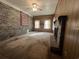 Cozy living room featuring a brick fireplace, wood paneled walls, and large windows at 51 Cleburn St., Georgetown, SC 29440