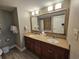 Bathroom featuring double sink vanity, granite countertops, decorative mirror and bright lighting at 5200 N Ocean Blvd. # 151, Myrtle Beach, SC 29577