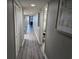 Hallway with gray wood floors, white trim and artwork on walls at 5200 N Ocean Blvd. # 151, Myrtle Beach, SC 29577