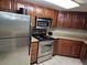 Kitchen with stainless steel appliances and brown cabinets at 5200 N Ocean Blvd. # 151, Myrtle Beach, SC 29577