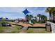 Outdoor playground with climbing structures, slide, and swing set on a wood chip surface at 5200 N Ocean Blvd. # 151, Myrtle Beach, SC 29577