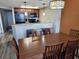 This bright kitchen features dark wood cabinetry and black appliances adjacent to a dining area at 5200 N Ocean Blvd. # 152, Myrtle Beach, SC 29577