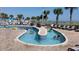 Relaxing outdoor lazy river with views of the ocean, surrounded by lounge chairs and palm trees at 5200 N Ocean Blvd. # 152, Myrtle Beach, SC 29577