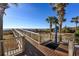 Wood boardwalk on a beach with a standing shower for rinsing off after swimming at 5200 N Ocean Blvd. # 155, Myrtle Beach, SC 29577