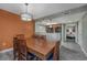 Dining area with a wood table and view to the kitchen and bedroom at 5200 N Ocean Blvd. # 155, Myrtle Beach, SC 29577