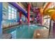 A large indoor pool featuring thrilling slides, vibrant murals, and a spacious area for water fun, perfect for year-round enjoyment at 5200 N Ocean Blvd. # 155, Myrtle Beach, SC 29577