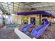 Indoor waterpark area with purple slides and smaller pool for relaxation at 5200 N Ocean Blvd. # 155, Myrtle Beach, SC 29577