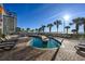 Beautiful waterfront pool with chairs and palm trees around the deck at 5200 N Ocean Blvd. # 155, Myrtle Beach, SC 29577