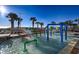 A colorful splash pad with playful water features provides an exciting outdoor experience next to lounge chairs and the ocean at 5200 N Ocean Blvd. # 155, Myrtle Beach, SC 29577