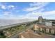 Breathtaking aerial view of a beach, ocean, and coastline with high rise buildings against a blue sky and scattered clouds at 5511 North Ocean Blvd. # 1105, Myrtle Beach, SC 29577