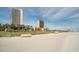 Wide sandy beach with distant condos offering scenic ocean views at 5511 North Ocean Blvd. # 1105, Myrtle Beach, SC 29577