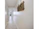 Long, well-lit hallway featuring neutral tile floors and a decorative bicycle on the wall at 5511 North Ocean Blvd. # 1105, Myrtle Beach, SC 29577