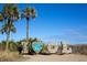 A beach side photo opportunity with wooden I, O, L letters and a logo for 