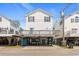 Exterior view of the elevated beach house with a large deck and covered parking area at 6001 -1005 S Kings Hwy., Myrtle Beach, SC 29575