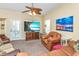 Comfortable living room featuring a ceiling fan, TV, and a large window for natural light at 6001 -1005 S Kings Hwy., Myrtle Beach, SC 29575