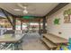 View of covered porch with tables, benches, ceiling fan, and fun decor at 6001 -1005 S Kings Hwy., Myrtle Beach, SC 29575