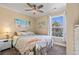 Cozy bedroom with beach-themed decor, ceiling fan, and natural light from a large window at 6001-L11 South Kings Hwy., Myrtle Beach, SC 29575