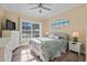 Cozy bedroom featuring a ceiling fan, window, and beach-themed bedding at 6001-L11 South Kings Hwy., Myrtle Beach, SC 29575