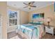 Inviting bedroom featuring a tropical-themed bedspread, matching wall art, and a ceiling fan at 6001-L11 South Kings Hwy., Myrtle Beach, SC 29575