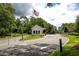 View of the community entry gate with guard house and US flag at 601 Gloucester Terrace Circle # 3-A, Myrtle Beach, SC 29572