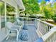 Cozy front porch features white wicker chairs and blue patterned cushions, creating an inviting outdoor space at 601 Gloucester Terrace Circle # 3-A, Myrtle Beach, SC 29572