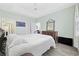 Bedroom with ceiling fan, wood dresser, light blue walls, and view of dining area at 601 N Hillside Dr. # 4632, North Myrtle Beach, SC 29582