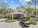 Community clubhouse with a parking area, manicured landscaping and palm trees at 601 N Hillside Dr. # 4632, North Myrtle Beach, SC 29582