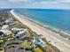 Breathtaking aerial view of the coastline and community buildings, showcasing oceanfront living at 645 Retreat Beach Circle, Pawleys Island, SC 29585