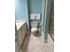 Bathroom with a light blue accent wall, neutral tile flooring, a white toilet, and a shower with sliding doors at 645 Retreat Beach Circle, Pawleys Island, SC 29585