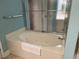 Close-up of a jetted bathtub in the bathroom with a shower-tub combination with sliding doors at 645 Retreat Beach Circle, Pawleys Island, SC 29585