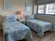 This bedroom has two twin-sized beds with side tables and lamps, and a window with blinds at 645 Retreat Beach Circle, Pawleys Island, SC 29585