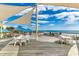 Inviting outdoor patio featuring several tables and chairs with beach and ocean views in the distance at 645 Retreat Beach Circle, Pawleys Island, SC 29585