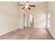 Bedroom with neutral carpet, ceiling fan, and view to another room through a doorway at 654 Old Castle Loop, Myrtle Beach, SC 29579