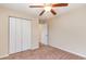 Cozy bedroom with neutral carpet, a ceiling fan, and closet with folding doors for storage at 654 Old Castle Loop, Myrtle Beach, SC 29579