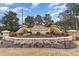 Community sign with beautiful stone work and landscaping at 654 Old Castle Loop, Myrtle Beach, SC 29579