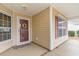 Inviting front porch with decorative wreath, colorful mat, and red shutters at 654 Old Castle Loop, Myrtle Beach, SC 29579