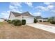 Attached garage with a white garage door, surrounded by meticulously maintained landscaping at 654 Old Castle Loop, Myrtle Beach, SC 29579