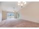 Bright living room with neutral carpet, ceiling fan, and sliding glass doors leading to a view of the community at 654 Old Castle Loop, Myrtle Beach, SC 29579