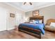 Cozy bedroom with a wooden bed frame, blue bedding and an accent chair at 685 Tidal Point Ln., Myrtle Beach, SC 29579