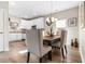 Bright dining area with a wood table, upholstered chairs, chandelier and white kitchen cabinets at 685 Tidal Point Ln., Myrtle Beach, SC 29579