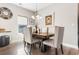 Dining area features a wood table with upholstered chairs, chandelier, and neutral wall decor at 685 Tidal Point Ln., Myrtle Beach, SC 29579