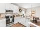 Bright kitchen featuring stainless appliances, granite countertops, an adjacent dining area, and hardwood floors at 685 Tidal Point Ln., Myrtle Beach, SC 29579