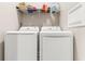 Bright laundry room with stacked washer and dryer and shelving at 685 Tidal Point Ln., Myrtle Beach, SC 29579