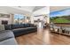 Spacious living room features a gray sectional couch, hardwood floors, and television at 685 Tidal Point Ln., Myrtle Beach, SC 29579