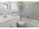 This bathroom features a tub with shower, white cabinets, and soft grey wall tiles at 693 Mallard Lake Dr., Myrtle Beach, SC 29577