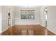 Cozy dining room featuring hardwood floors, a modern chandelier, and views of the yard and kitchen at 693 Mallard Lake Dr., Myrtle Beach, SC 29577