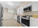 Well-lit kitchen with stainless steel appliances, white cabinets, and neutral countertops at 693 Mallard Lake Dr., Myrtle Beach, SC 29577