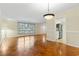 Bright living room with hardwood floors, a window with a view, and an open doorway to the kitchen at 693 Mallard Lake Dr., Myrtle Beach, SC 29577