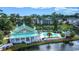 Beautiful aerial view of community pool and amenity center surrounded by lush landscaping and lake at 702 Compass Point Dr., North Myrtle Beach, SC 29582